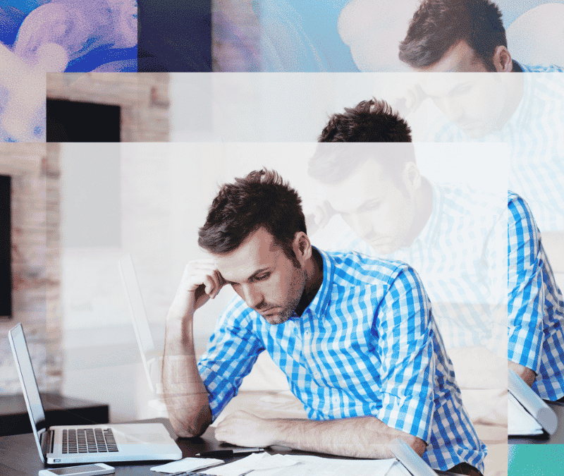 A troubled business owner working on the business' cashflow in his laptop while using calculator and tracking the history of data on the documents