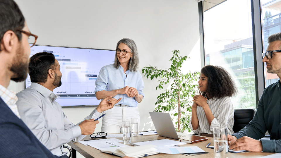 Business owner with its employees on a weekly huddle meetings to track activities and outcomes of the business.