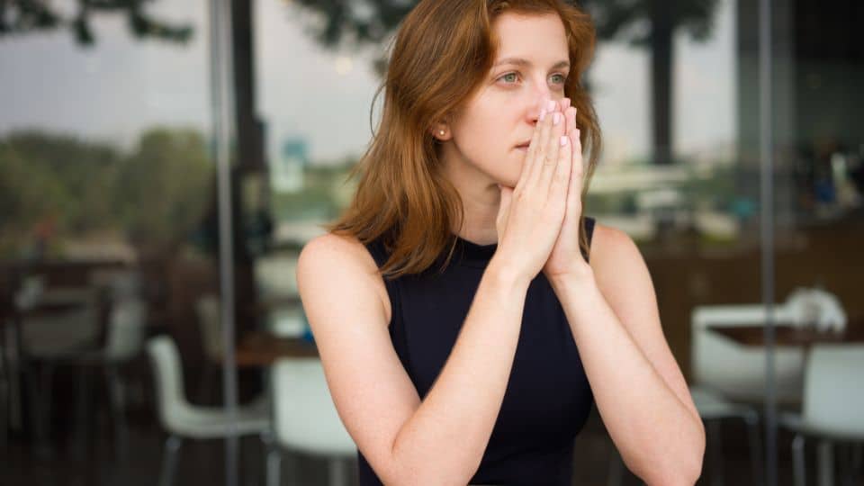 Troubled Business Woman thinking of how she can approach her employee for his low performances, and have that awkward difficult conversation.