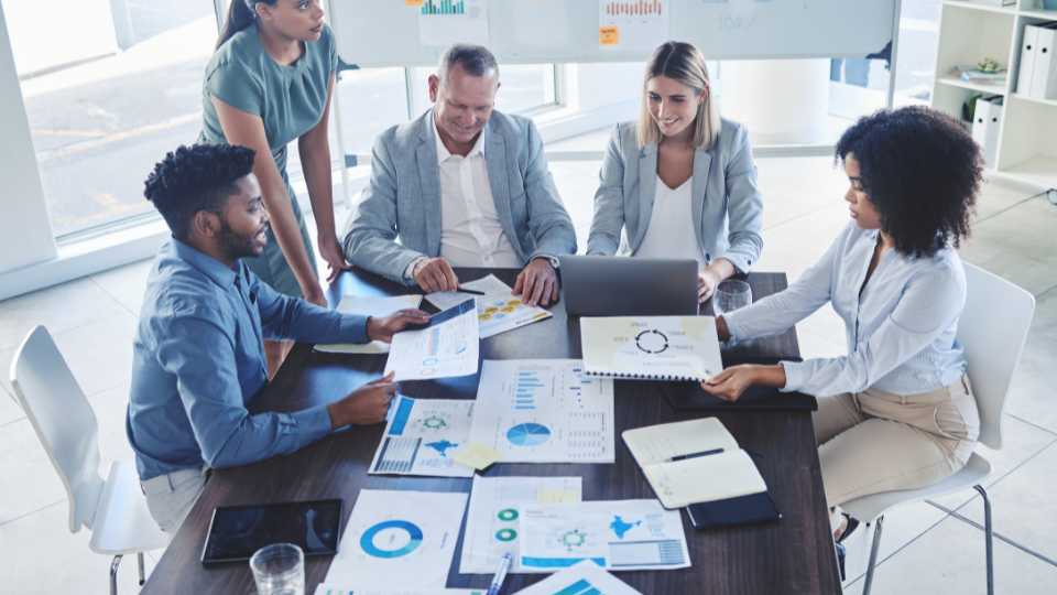 Business owner demonstrating open book management by allowing employees to contribute their ideas during meeting.