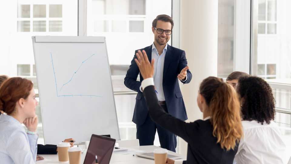 Business owner demonstrating open book management by allowing employees to contribute their ideas during meeting.