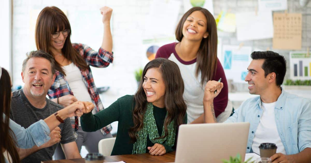 Two Employees having conflict and lack of trust in front of a laptop