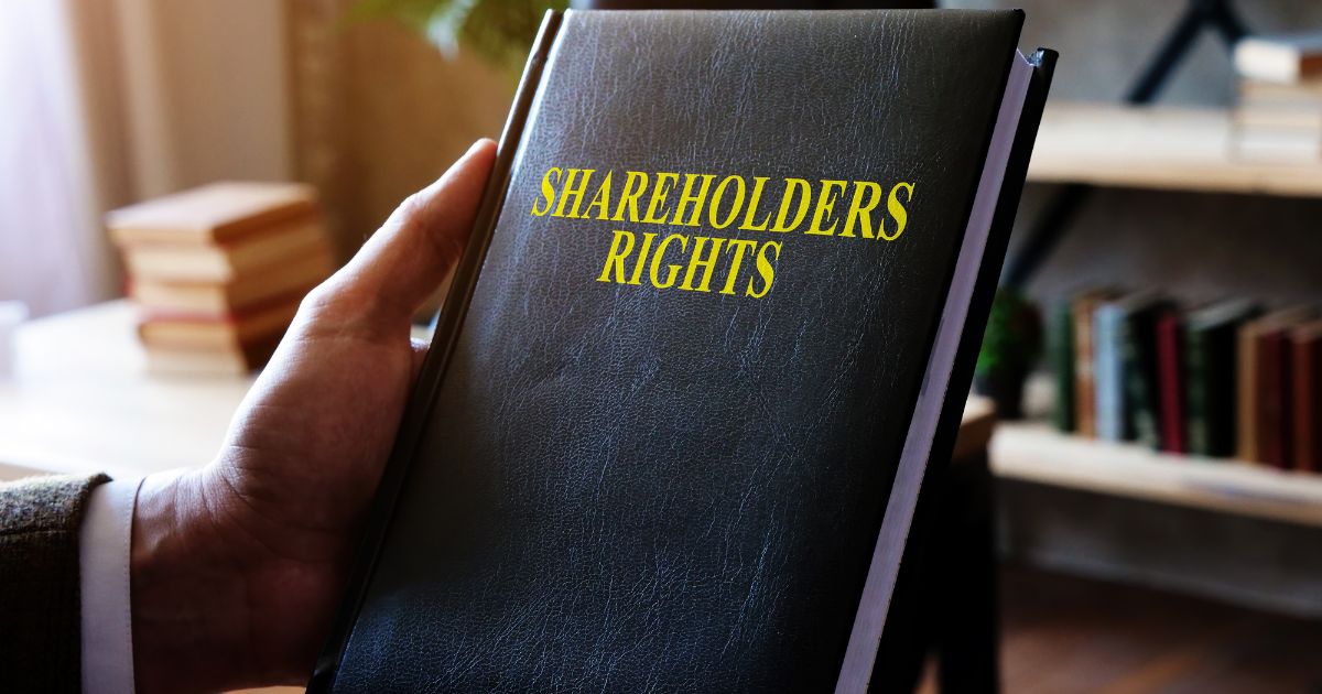 Business Owner holding a book of shareholders right in his hands