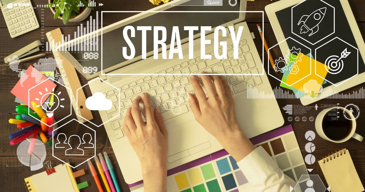 Hands of a business owner typing in a laptop while showing business strategy