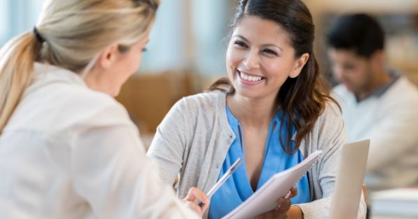 A woman business representative giving a woman customer exceptional customer service