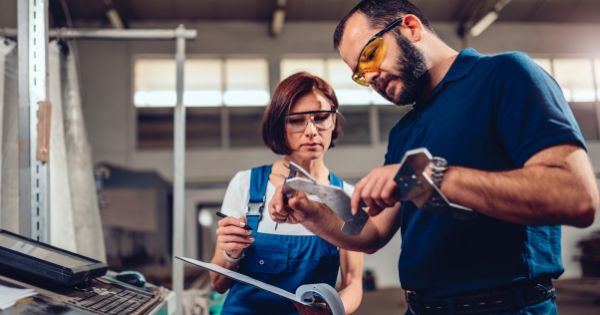 A business man with his woman employee inspecting the quality of a product of a business