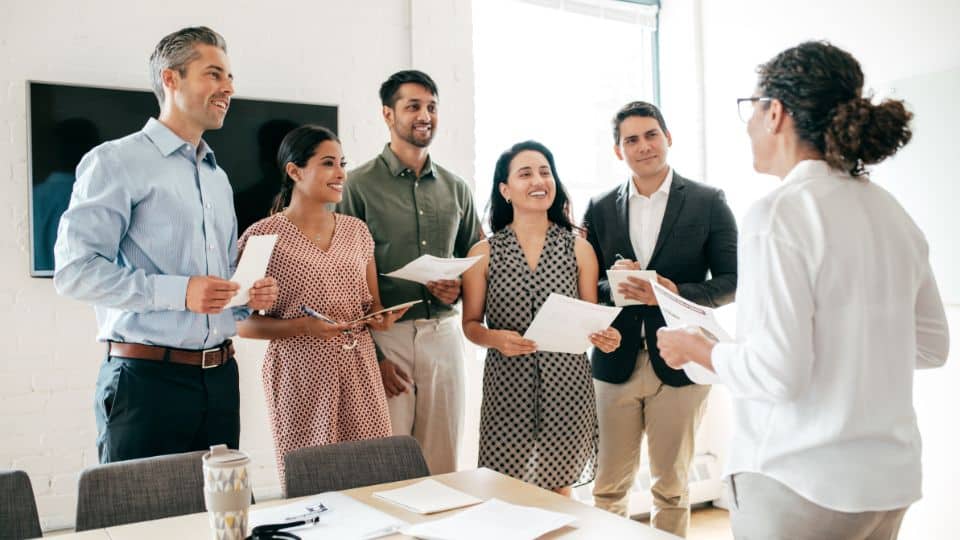 Business Woman Coaching her five employees inside an office