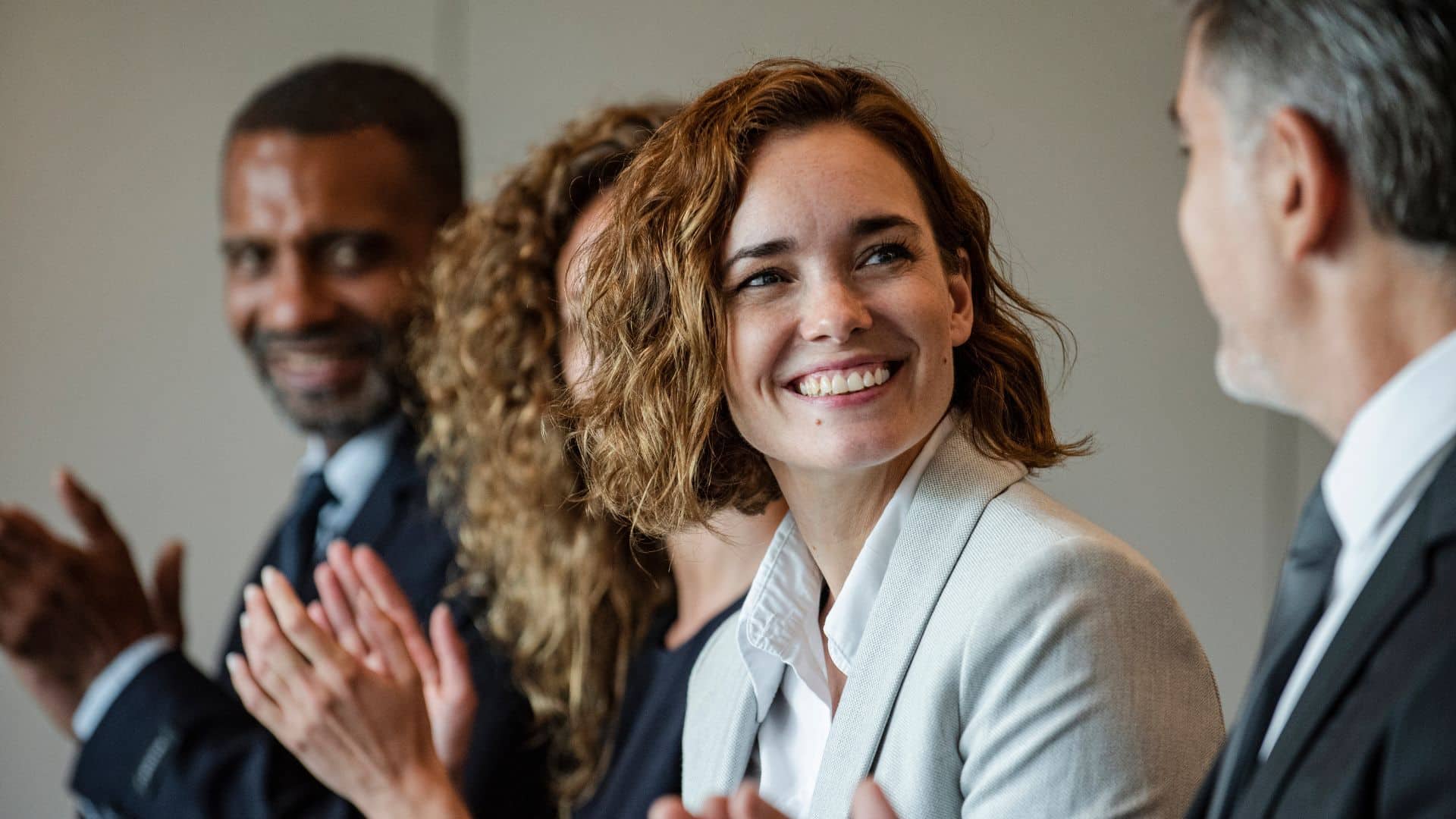 woman in a meeting with board directors smiling